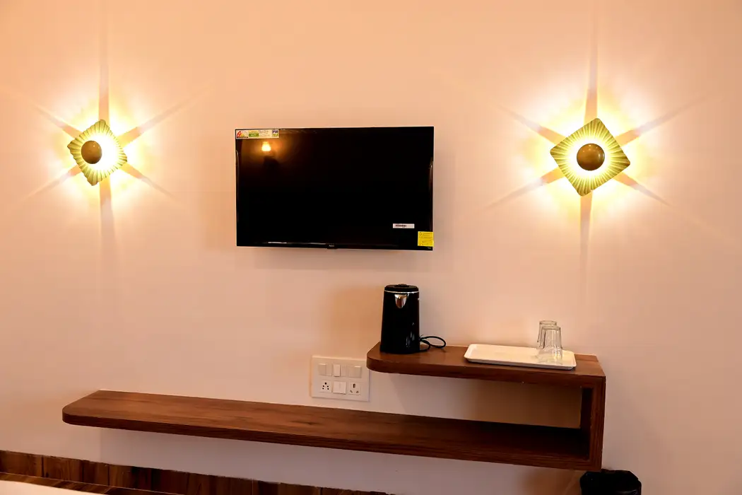 Cottage desk with a television, kettle and wall lamps